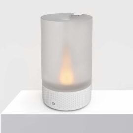 VOTIV 7 sitting on a white pedestal displaying tranquil flameless candlelight